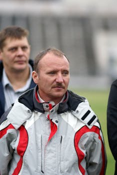 Close-up of men outdoors in sports gear during a daytime event.