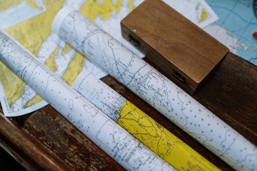Close-up of rolled nautical maps on a wooden table, perfect for navigation themes.
